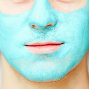 Portrait of young handsome man with facial mask.